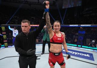 Raquel Pennington gets her hand raised after defeating Apsen Ladd at UFC 273