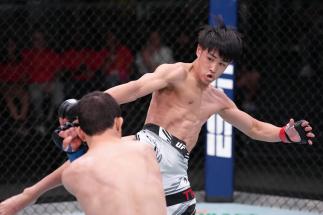 Tatsuro Taira of Japan kicks Carlos Candelario in a flyweight fight at UFC APEX on May 14, 2022 in Las Vegas, Nevada. (Photo by Jeff Bottari/Zuffa LLC)