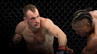 LAS VEGAS, NEVADA - SEPTEMBER 25: (L-R) Uros Medic of Serbia punches Jalin Turner in their lightweight fight during the UFC 266 event on September 25, 2021 in Las Vegas, Nevada. (Photo by Jeff Bottari/Zuffa LLC)