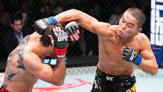 Asu Almabayev punches Matheus Nicolau in a flyweight fight during the UFC Fight Night event at UFC APEX on October 19, 2024 in Las Vegas, Nevada. (Photo by Jeff Bottari/Zuffa LLC)