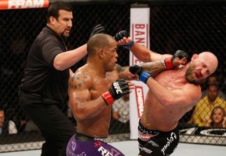 LAS VEGAS, NV - JANUARY 03: (L-R) Hector Lombard punches Josh Burkman in their welterweight bout during the UFC 182 event on at the MGM Grand Garden Arena January 3, 2015 in Las Vegas, Nevada. (Photo by Josh Hedges/Zuffa LLC/Zuffa LLC via Getty Images)