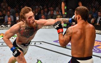 LAS VEGAS, NV - JULY 11: (L-R) Conor McGregor punches Chad Mendes in their UFC interim featherweight title fight during the UFC 189 event inside MGM Grand Garden Arena on July 11, 2015 in Las Vegas, Nevada. (Photo by Josh Hedges/Zuffa LLC/Zuffa LLC via