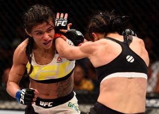 LAS VEGAS, NV - JULY 08: (L-R) Claudia Gadelha of Brazil punches Joanna Jedrzejczyk of Poland in their women's strawweight championship bout during The Ultimate Fighter Finale event at MGM Grand Garden Arena on July 8, 2016 in Las Vegas, Nevada. (Photo