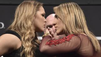RIO DE JANEIRO, BRAZIL - MARCH 20: (EDITORS NOTE: Retransmission with alternate crop.) UFC Women's Bantamweight Champion Ronda Rousey of the United States and Bethe Correia of Brazil face off as UFC President Dana White (C) stands in during the 189 World