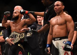 LAS VEGAS, NV - SEPTEMBER 05: Demetrious Johnson (left) reacts to his victory over John Dodson (right) in their flyweight championship bout during the UFC 191 event inside MGM Grand Garden Arena on September 5, 2015 in Las Vegas, Nevada. (Photo by Jeff B