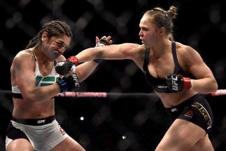 RIO DE JANEIRO, BRAZIL - AUGUST 01: Ronda Rousey of the United States punches Bethe Correia of Brazil in their bantamweight title fight during the UFC 190 Rousey v Correia at HSBC Arena on August 1, 2015 in Rio de Janeiro, Brazil. (Photo by Buda Mendes/