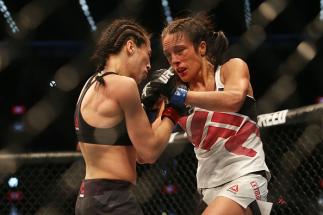 MELBOURNE, AUSTRALIA - NOVEMBER 15: Joanna Jedrzejczyk of Poland (L) and Valerie Letourneau of Canada compete in their UFC women's strawweight championship bout during the UFC 193 event at Etihad Stadium on November 15, 2015 in Melbourne, Australia. (Ph