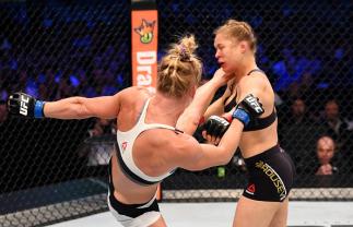 MELBOURNE, AUSTRALIA - NOVEMBER 15: (L-R) Holly Holm lands a left-high kick against Ronda Rousey in the second round of their UFC women's bantamweight championship bout during the UFC 193 event at Etihad Stadium on November 15, 2015 in Melbourne, Australi