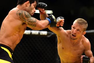 LAS VEGAS, NV - JULY 09: (R-L) TJ Dillashaw punches Raphael Assuncao of Brazil in their bantamweight bout during the UFC 200 event on July 9, 2016 at T-Mobile Arena in Las Vegas, Nevada. (Photo by Harry How/Zuffa LLC/Zuffa LLC via Getty Images)