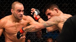 JULY 07: (L-R) Eddie Alvarez connects with a left against Rafael Dos Anjos of Brazil in their lightweight championship bout during the UFC Fight Night event inside the MGM Grand Garden Arena on July 7, 2016 in Las Vegas, Nevada. (Photo by Jeff Bottari/Zuf