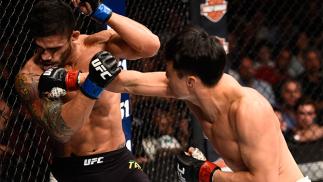 JULY 08: (R-L) Doo Ho Choi of South Korea knocks down Thiago Tavares of Brazil with a punch in their featherweight bout during The Ultimate Fighter Finale event at MGM Grand Garden Arena on July 8, 2016 in Las Vegas, Nevada. (Photo by Jeff Bottari/Zuffa L