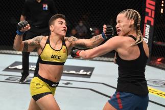ABU DHABI, UNITED ARAB EMIRATES - OCTOBER 18: (L-R) Jessica Andrade of Brazil punches Katlyn Chookagian in their women's flyweight bout