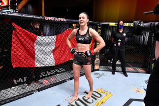 Antonina Shevchenko of Kyrgyzstan celebrates her TKO victory over Ariane Lipski of Brazil in their women's flyweight bout during the UFC 255