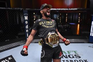 Deiveson Figueiredo of Brazil celebrates his submission victory over Alex Perez in their flyweight championship bout during the UFC 255