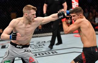 MELBOURNE, AUSTRALIA - OCTOBER 06: (L-R) Dan Hooker of New Zealand punches Al Iaquinta in their lightweight fight during the UFC 243 e