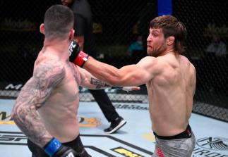LAS VEGAS, NEVADA - AUGUST 08: In this handout photo provided by UFC, (R-L) Andrew Sanchez punches Wellington Turman of Brazil