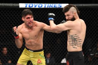 PHOENIX, ARIZONA - FEBRUARY 17: (L-R) Vicente Luque punches Bryan Barberena in their welterweight bout during the UFC Fight Night