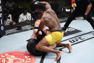 LAS VEGAS, NEVADA - MARCH 13: (R-L) Ryan Spann punches Misha Cirkunov of Latvia in a light heavyweight fight during the UFC Fight Night