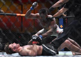AS VEGAS, NEVADA - MARCH 27: (R-L) Francis Ngannou of Cameroon punches Stipe Miocic in their UFC heavyweight championship fight during the UFC 260