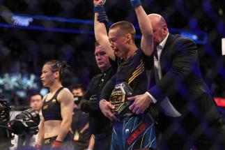 JACKSONVILLE, FL - APRIL 24: Rose Namajunas of the United States celebrates after beating Zhang Weili of China during the Women's Strawweight Title bout of UFC 261