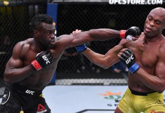 LAS VEGAS, NEVADA - OCTOBER 31: (L-R) Uriah Hall of Jamaica punches Anderson Silva of Brazil in a middleweight bout during the UFC Fight Night event