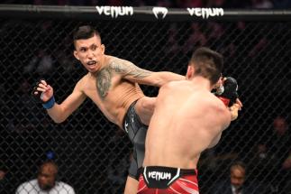 Jeff Molina kicks Aoriqileng of China in their flyweight bout during the UFC 261