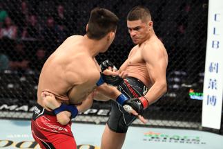 ACKSONVILLE, FLORIDA - APRIL 24: (R-L) Kazula Vargas of Mexico kicks Rongzhu of China in their lightweight bout during the UFC 261