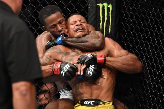 JACKSONVILLE, FLORIDA - APRIL 24: (L-R) Randy Brown of Jamaica attempts to submit Alex Oliveira of Brazil in their welterweight bout during the UFC 261