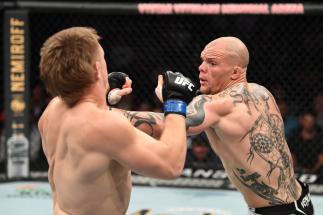 JACKSONVILLE, FLORIDA - APRIL 24: (R-L) Anthony Smith punches Jim Crute of Australia in their light heavyweight bout during the UFC 261