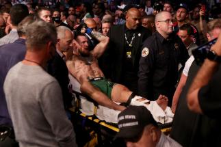LAS VEGAS, NEVADA - JULY 10: Conor McGregor of Ireland is carried out of the arena on a stretcher after injuring his ankle in the first round of his lightweight bout against Dustin Poirier during UFC 264