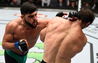 TORONTO, CANADA - DECEMBER 10: (L-R) Kelvin Gastelum punches Tim Kennedy in their middleweight bout during the UFC 206 event inside the Air Canada Centre on December 10, 2016 in Toronto, Ontario, Canada. (Photo by Jeff Bottari/Zuffa LLC/Zuffa LLC via Get