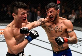 TORONTO, CANADA - DECEMBER 10: (R-L) Cub Swanson punches Dooho Choi of South Korea in their featherweight bout during the UFC 206 event inside the Air Canada Centre on December 10, 2016 in Toronto, Ontario, Canada. (Photo by Jeff Bottari/Zuffa LLC/Zuffa