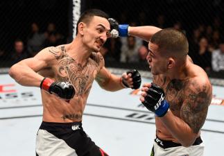 TORONTO, CANADA - DECEMBER 10: (R-L) Anthony Pettis punches Max Holloway in their interim UFC featherweight championship bout during the UFC 206 event inside the Air Canada Centre on December 10, 2016 in Toronto, Ontario, Canada. (Photo by Jeff Bottari/Z