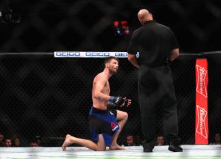 LAS VEGAS, NV - DECEMBER 30: Tim Means (blue shorts) speaks with referee Dan Miragliotta after his welterweight bout during the UFC 207 event on December 30, 2016 in Las Vegas, Nevada. (Photo by Christian Petersen/Getty Images)
