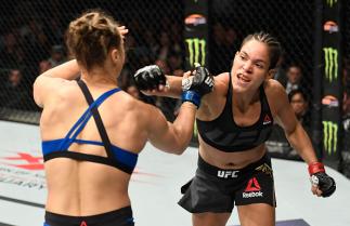 LAS VEGAS, NV - DECEMBER 30: (R-L) Amanda Nunes of Brazil punches Ronda Rousey in their UFC women's bantamweight championship bout during the UFC 207 event at T-Mobile Arena on December 30, 2016 in Las Vegas, Nevada. (Photo by Josh Hedges/Zuffa LLC/Zuffa
