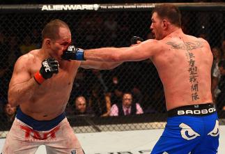 PHOENIX, AZ - DECEMBER 13: (R-L) Stipe Miocic punches Junior Dos Santos of Brazil in their heavyweight fight during the UFC Fight Night event at the U.S. Airways Center on December 13, 2014 in Phoenix, Arizona. (Photo by Josh Hedges/Zuffa LLC/Zuffa LLC