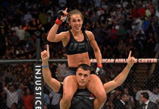DALLAS, TX - MAY 13: Joanna Jedrzejczyk raises her hands after facing Jessica Andrade in their UFC women's strawweight championship fight during the UFC 211 event at the American Airlines Center on May 13, 2017 in Dallas, Texas. (Photo by Josh Hedges/Zu