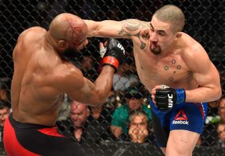 LAS VEGAS, NV - JULY 08:  (R-L) Robert Whittaker of New Zealand punches Yoel Romero of Cuba in their interim UFC middleweight championship bout during the UFC 213 event at T-Mobile Arena on July 8, 2017 in Las Vegas, Nevada.  (Photo by Josh Hedges/Zuffa L