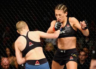 NEW YORK, NY - NOVEMBER 04: Rose Namajunas lands a punch against Joanna Jedrzejczyk of Poland in their UFC women's strawweight championship bout during the UFC 217 event at Madison Square Garden on November 4, 2017 in New York City. (Photo by Josh Hedge
