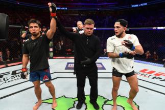 DETROIT, MI - DECEMBER 02: (L-R) Henry Cejudo celebrates after defeating Sergio Pettis in their flyweight bout during the UFC 218 event inside Little Caesars Arena on December 02, 2017 in Detroit, Michigan. (Photo by Josh Hedges/Zuffa LLC/Zuffa LLC via G