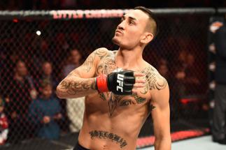 DETROIT, MI - DECEMBER 02: Max Holloway signals to the crowd as he enters the Octagon prior to facing Jose Aldo of Brazil in their UFC featherweight championship bout during the UFC 218 event inside Little Caesars Arena on December 02, 2017 in Detroit, M