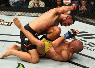 DETROIT, MI - DECEMBER 02: (L-R) Max Holloway punches Jose Aldo of Brazil in their UFC featherweight championship bout during the UFC 218 event inside Little Caesars Arena on December 02, 2017 in Detroit, Michigan. (Photo by Josh Hedges/Zuffa LLC/Zuffa L