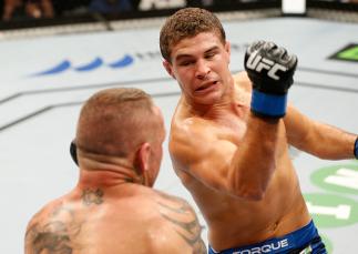 SYDNEY, AUSTRALIA - NOVEMBER 08: (R-L) Al Iaquinta of the United States punches Ross Pearson of England in their lightweight bout during the UFC Fight Night event inside Allphones Arena on November 8, 2014 in Sydney, Australia. (Photo by Josh Hedges/Zuf