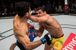 BRASILIA, BRAZIL - SEPTEMBER 24: Renan Barao of Brazil punches Phillipe Nover of the United States in their flyyweight UFC bout during the UFC Fight Night event at Nilson Nelson gymnasium on September 24, 2016 in Brasilia, Brazil. (Photo by Buda Mendes/Zu