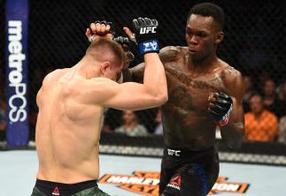 GLENDALE, AZ - APRIL 14: (R-L) Israel Adesanya of Nigeria punches Marvin Vettori of Italy in their middleweight fight during the UFC Fight Night event at the Gila Rivera Arena on April 14, 2018 in Glendale, Arizona. (Photo by Josh Hedges/Zuffa LLC/Zuffa