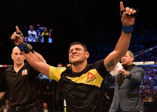 SINGAPORE - JUNE 17: Rafael Dos Anjos of Brazil celebrates after his decision victory over Tarec Saffiedine of Belgium in their welterweight bout during the UFC Fight Night event at the Singapore Indoor Stadium on June 17, 2017 in Singapore. (Photo by B