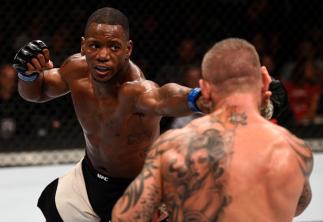 LAS VEGAS, NV - JULY 08: (L-R) Will Brooks punches Ross Pearson of England in their lightweight bout during The Ultimate Fighter Finale event at MGM Grand Garden Arena on July 8, 2016 in Las Vegas, Nevada. (Photo by Jeff Bottari/Zuffa LLC/Zuffa LLC via