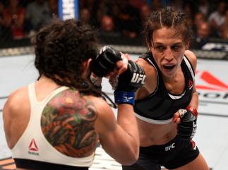 LAS VEGAS, NV - JULY 08: (R-L) Joanna Jedrzejczyk of Poland punches Claudia Gadelha of Brazil in their women's strawweight championship bout during The Ultimate Fighter Finale event at MGM Grand Garden Arena on July 8, 2016 in Las Vegas, Nevada. (Photo