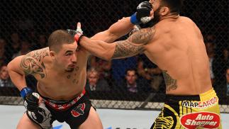 ADELAIDE, AUSTRALIA - MAY 10: (L-R) Robert Whittaker punches Brad Tavares in their middleweight bout during the UFC Fight Night event at the Adelaide Entertainment Centre on May 10, 2015 in Adelaide, Australia. (Photo by Josh Hedges/Zuffa LLC/Zuffa LLC