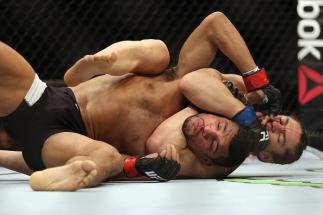 BOSTON, MA - JANUARY 17: Luke Sanders chokes Maximo Blanco in their featherweight bout during UFC Fight Night 81 at TD Banknorth Garden on January 17, 2016 in Boston, Massachusetts. (Photo by Tim Bradbury/Getty Images)